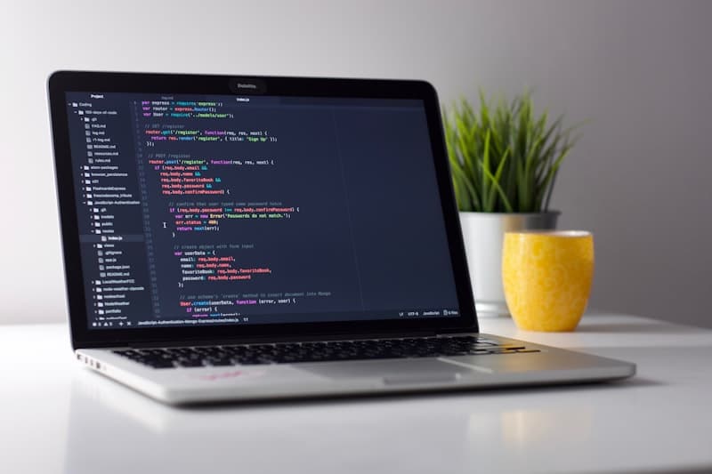 Laptop open on a desk with code on screen