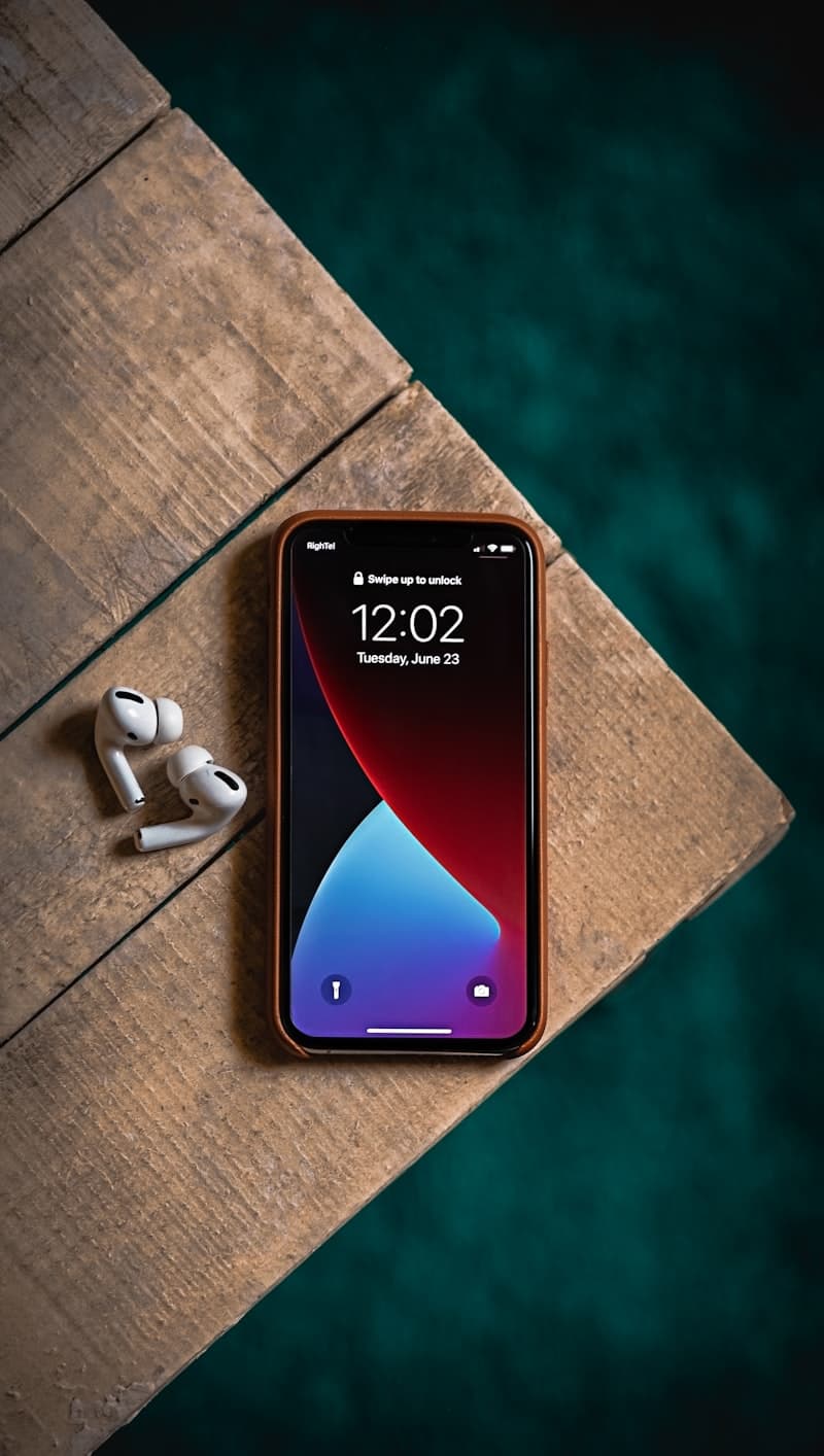 iPhone on desk next to Android smartphone