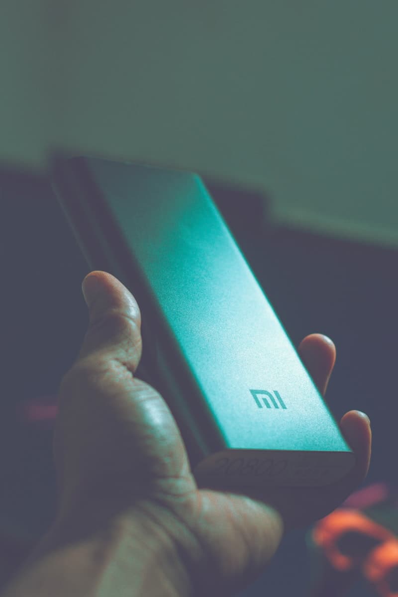 Phone charging on nightstand with dim light